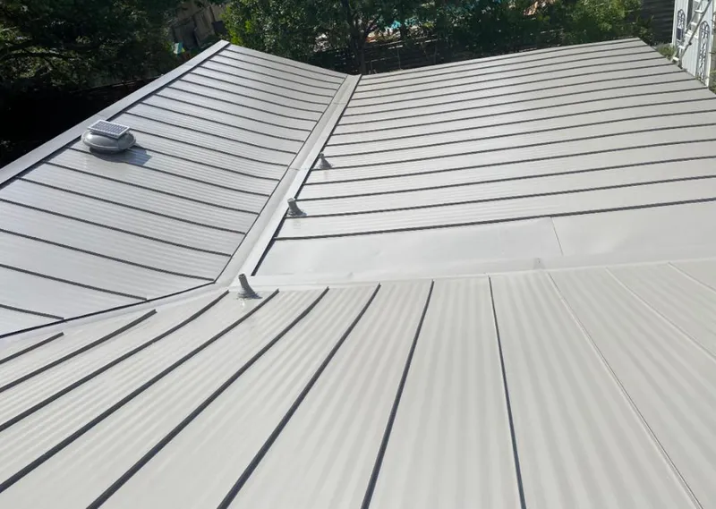 Solar attic fan installed on a metal roof for Roof Ventilation in Englewood Cliffs