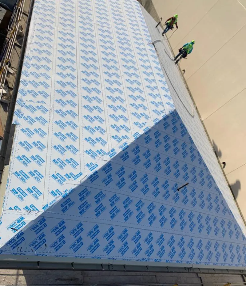 Professional roofers installing underlayment on a metal roof in Englewood Cliffs